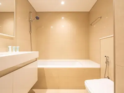 a bathroom with a bath tub and a toilet at Lavishly Elegant 2BR with Breathtaking Full Burj Khalifa View in Dubai