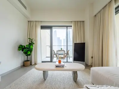 a hotel room with a bed and a coffee table at Lavishly Elegant 2BR with Breathtaking Full Burj Khalifa View in Dubai