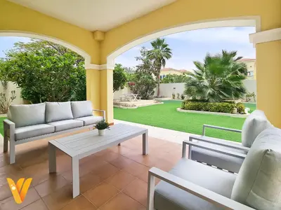 a living room with a couch and a table at Luxury 3BR Private Pool Villa and Elaborate Gardens in Dubai