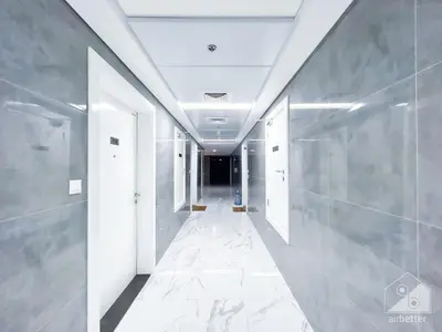 a hallway with white walls and a ceiling at NEW! Amazing Studio in Al Majan in Dubai