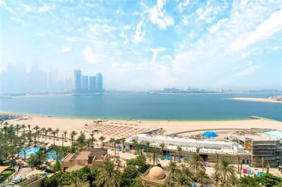 a view of a beach with buildings and the ocean at NEW! Exclusive Fairmont Penthouse private Pool-Gym in Dubai