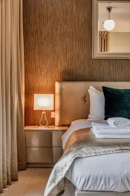a bedroom with a bed and a lamp on a table at Bellavista - Ultra Modern - 2BR - Boulevard Central - Burj Khalifa View in Dubai