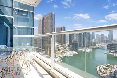 a balcony with a view of a river and buildings at Luxury 2BR with Breath-taking Dubai Marina Views in Dubai