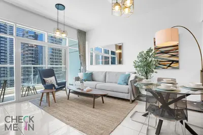 a living room with a couch and a table at Luxury 2BR with Breath-taking Dubai Marina Views in Dubai