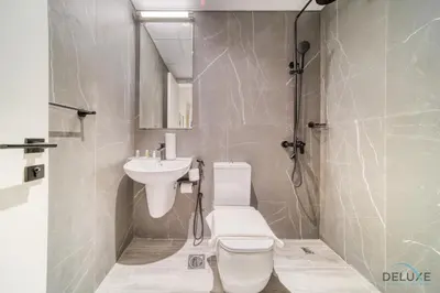 a bathroom with a toilet and a sink at Exquisite 2BR with Assistant Room at Mesk 1 Midtown Dubai Production City by Deluxe Holiday Homes in Dubai