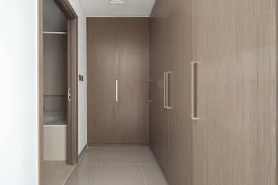 a hallway with two wooden doors in a room at Frank Porter - 17 Icon Bay in Dubai