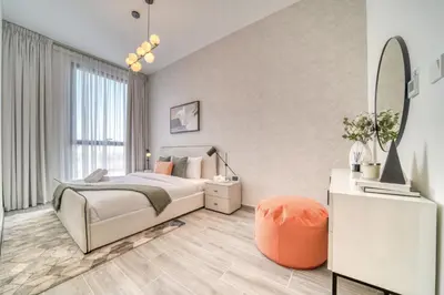 a bedroom with a bed and a mirror at Alluring 2BR with Assistant Room at Mesk 1 Midtown Dubai Production City by Deluxe Holiday Homes in Dubai