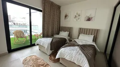 a bedroom with two beds and a balcony with a view at LUXURY 2 bedrooms 5 minutes from Burj Khalifa in Dubai