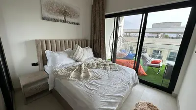 a bedroom with a bed and a large window at LUXURY 2 bedrooms 5 minutes from Burj Khalifa in Dubai