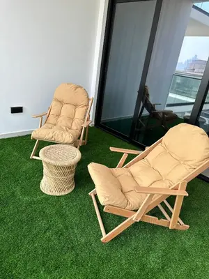two chairs and a table in a room with green grass at LUXURY 2 bedrooms 5 minutes from Burj Khalifa in Dubai