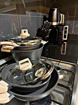 two pans sitting on top of a stove at Royal Maison Luxurious 2 Br in Business Bay in Dubai