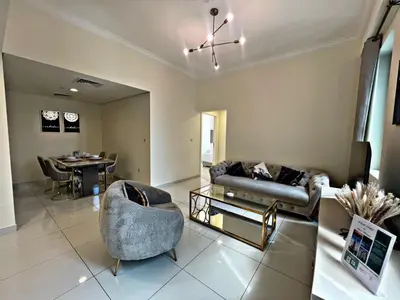 a living room with a couch and a table at Royal Maison Luxurious 2 Br in Business Bay in Dubai