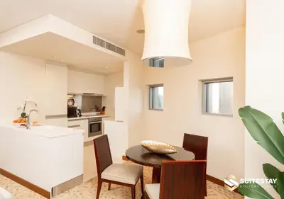 a kitchen and dining room with a table and chairs at Fashion Avenue - Dubai Mall in Dubai