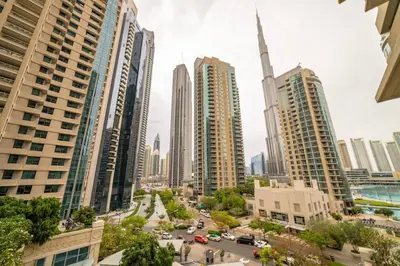 a view of a city with tall buildings at 2BR Burj View with Balcony, Pool, Gym & Walk to Dubai Mall in Dubai