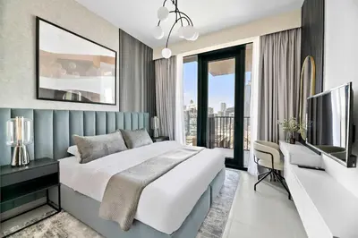 a bedroom with a large white bed and a desk at Silkhaus elegant and luxury 1BDR Downtown in Dubai