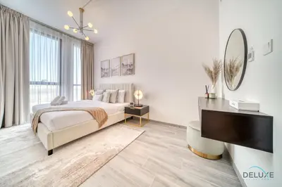 a bedroom with a bed and a piano at Charming 2BR with Assistant Room at Mesk 1 Midtown Dubai Production City by Deluxe Holiday Homes in Dubai