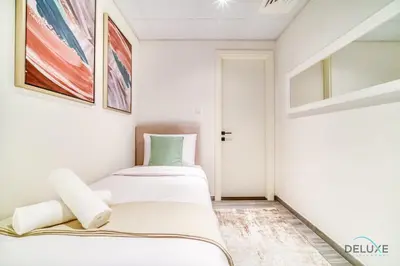 a small bedroom with two beds in it at Charming 2BR with Assistant Room at Mesk 1 Midtown Dubai Production City by Deluxe Holiday Homes in Dubai