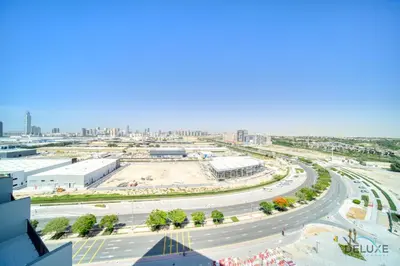an aerial view of a road in a city at Charming 2BR with Assistant Room at Mesk 1 Midtown Dubai Production City by Deluxe Holiday Homes in Dubai