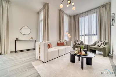 a living room with a couch and a table at Pleasant 2BR with Assistant Room at Mesk 1 Midtown Dubai Production City by Deluxe Holiday Homes in Dubai