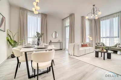 a living room with a table and chairs and a couch at Pleasant 2BR with Assistant Room at Mesk 1 Midtown Dubai Production City by Deluxe Holiday Homes in Dubai