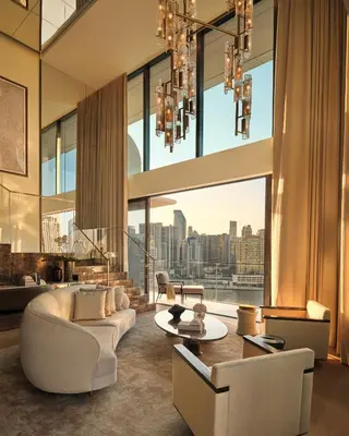 a living room with a view of a city at The Lana - Dorchester Collection in Dubai