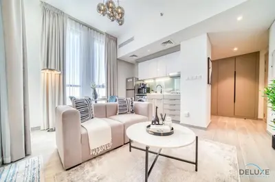 a living room with a couch and a table at Striking Studio at Mesk 1 Midtown Dubai Production City by Deluxe Holiday Homes in Dubai