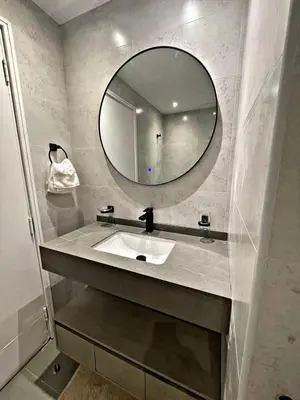 a bathroom with a sink and a mirror at Stunning Duplex Studio in JLT in Dubai