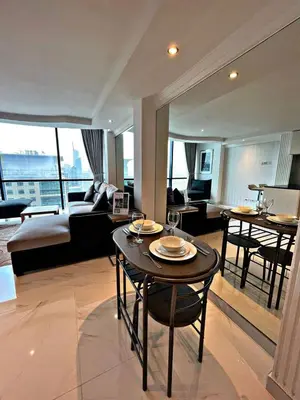 a living room with a couch and a table with chairs at Stunning Duplex Studio in JLT in Dubai