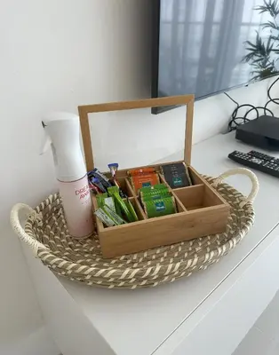 a basket sitting on a desk with a lot of items at Tranquil Studio in Damac Hills in Dubai