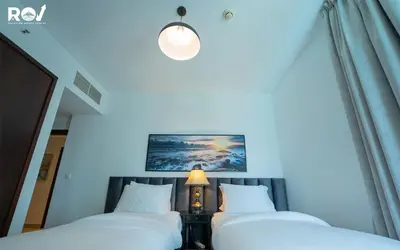 two beds in a room with a lamp next to them at Luxury 2 Bedroom Suite with Full Burj Khalifa View in Dubai