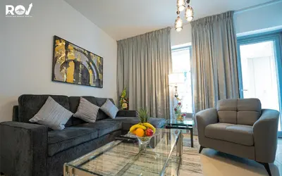 a living room with a couch and a glass table at Luxury 2 Bedroom Suite with Full Burj Khalifa View in Dubai