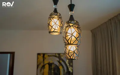 three lights hanging from the ceiling in a room at Luxury 2 Bedroom Suite with Full Burj Khalifa View in Dubai