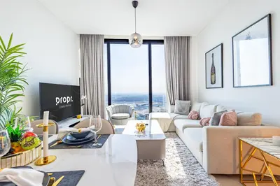 a living room with a couch and a table at Address JBR: Beachfront Bliss & Sky-high Luxury in Dubai