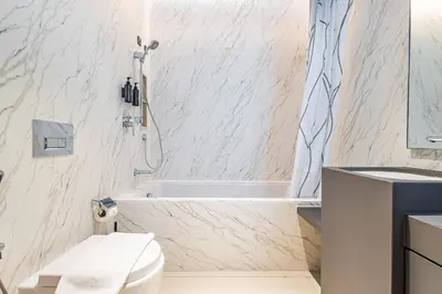 a bathroom with a tub and a toilet and a sink at Address JBR: Beachfront Bliss & Sky-high Luxury in Dubai