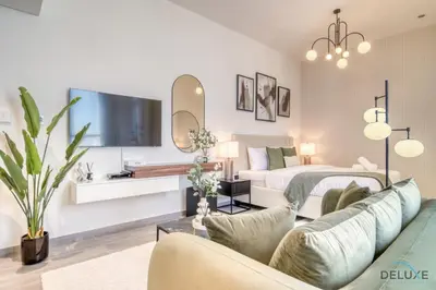 a living room with a bed and a couch at Upscale Studio at Mesk 1 Midtown Dubai Production City by Deluxe Holiday Homes in Dubai