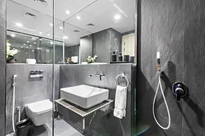 a bathroom with a sink and a shower at ALiving Luxury Studio I Nicholas Residence, JVC in Dubai