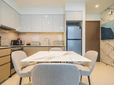 a kitchen with a white table and chairs at Superior 1BR In Burj Royale - Downtown Dubai in Dubai