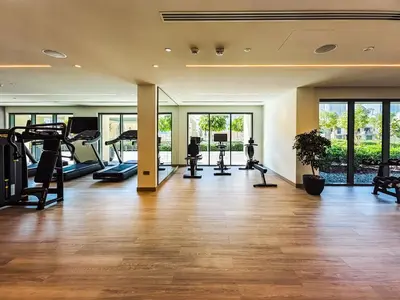 an empty gym with treadmills and elliptical machines at Superior 1BR In Burj Royale - Downtown Dubai in Dubai