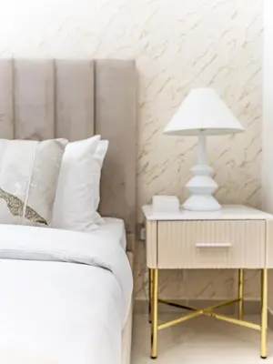 a bedroom with a bed and a lamp on a night stand at Radiant 1BR in Burj Royale - Downtown Dubai in Dubai