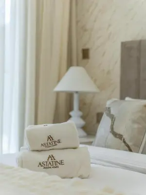 a pile of towels sitting on top of a bed at Radiant 1BR in Burj Royale - Downtown Dubai in Dubai