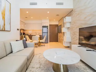 a living room with a couch and a table at Radiant 1BR in Burj Royale - Downtown Dubai in Dubai
