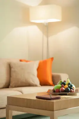 a tray of fruit on a coffee table in front of a couch at Carlton Downtown Hotel in Dubai