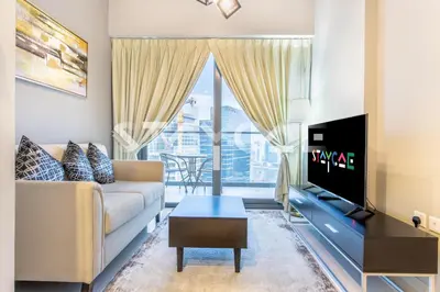 a living room with a couch and a tv at Staycae Holiday Homes - ZADA in Dubai