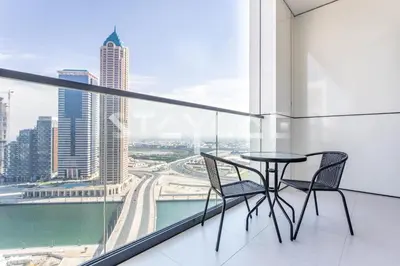 a table and two chairs on a balcony with a view at Staycae Holiday Homes - ZADA in Dubai