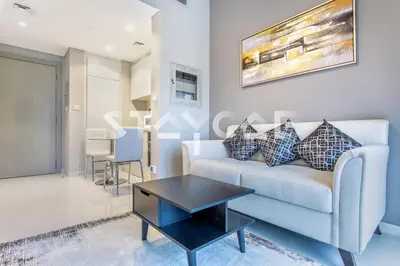 a living room with a couch and a table at Staycae Holiday Homes - ZADA in Dubai