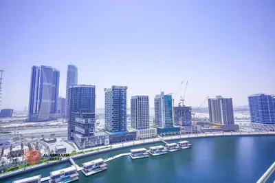 a view of a city with boats in the water at Alashrafia Saray- Wonderous Studio in Canal Views in Dubai