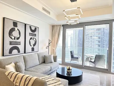 a living room with a couch and a table at Opera Grand by Luxstay Holiday Homes in Dubai