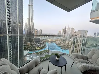 a room with chairs and a view of a city at Opera Grand by Luxstay Holiday Homes in Dubai