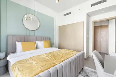 a bedroom with a large bed and a mirror at Silkhaus brand new 1BDR in Creek Harbour in Dubai