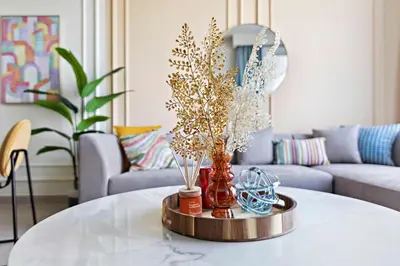 a living room with a table with vases on it at Silkhaus brand new 1BDR in Creek Harbour in Dubai